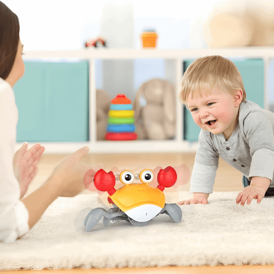 baby play with an orange crab musical baby toys - un bébé joue avec un jouet orange musical en forme de crabe